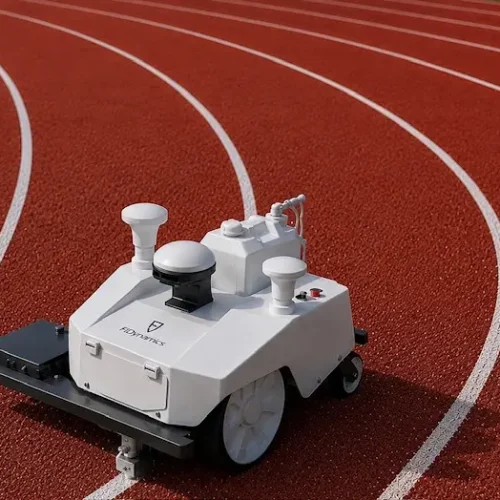 Autonomous GPS line-marking robot painting precise white lane lines on an outdoor athletics running track.