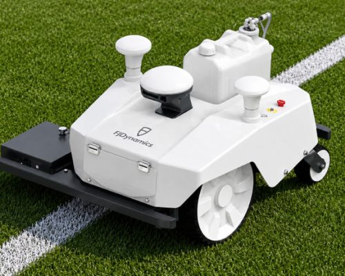 Autonomous GPS sports field line-marking robot painting a precise white boundary line on green grass.